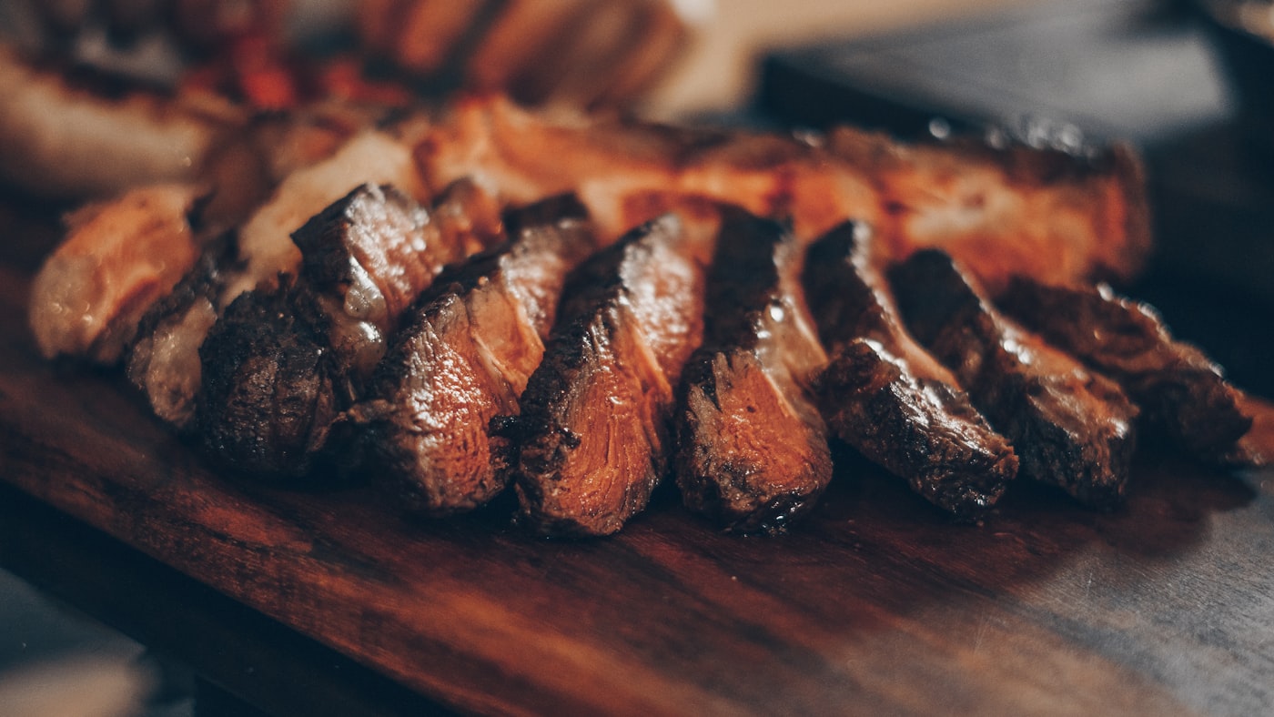 Sliced reverse-seared steak with a dark crust and a pink, rested interior